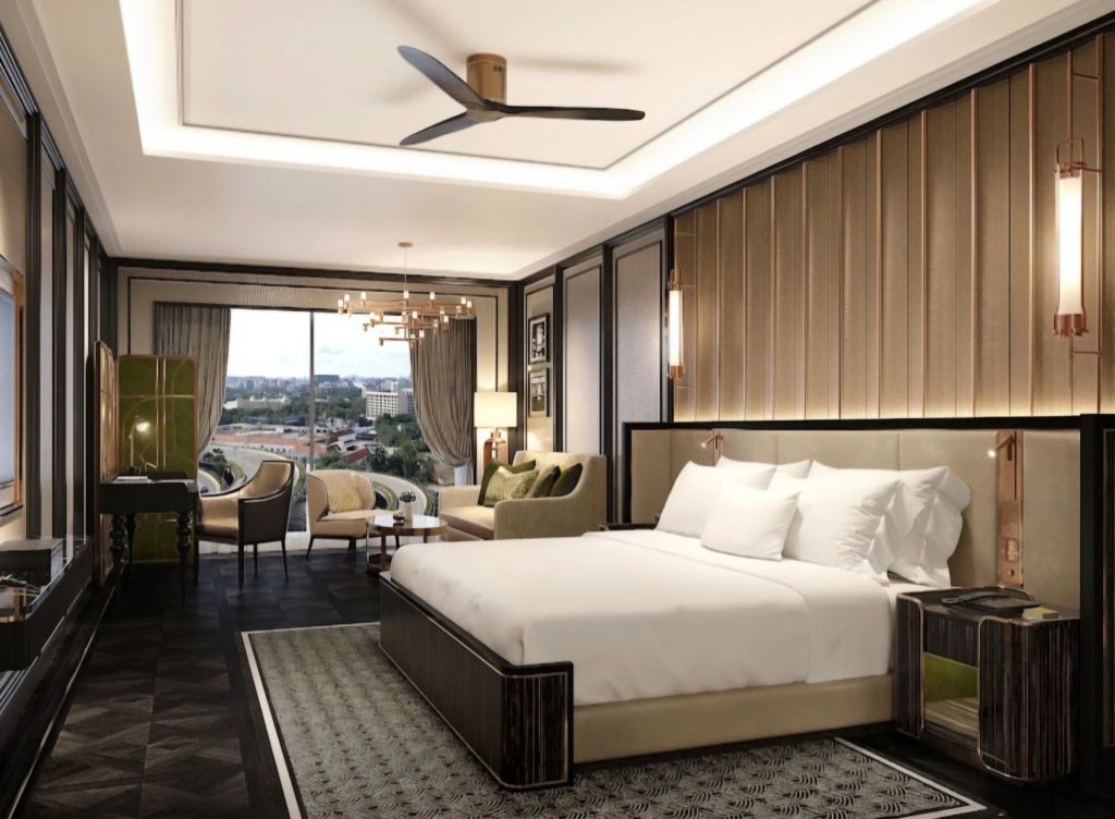 Luxurious hotel room at Fairmont Mumbai featuring a king-size bed, stylish decor, and large windows with a city view.