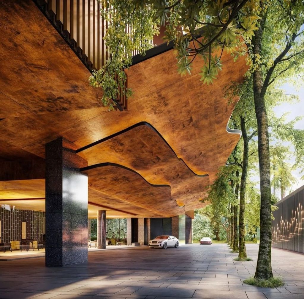 The entrance of Aman Nai Lert Bangkok, showcasing a striking architectural design with a wooden ceiling, sleek pillars, and surrounding trees, creating a harmonious blend of nature and modernity.
