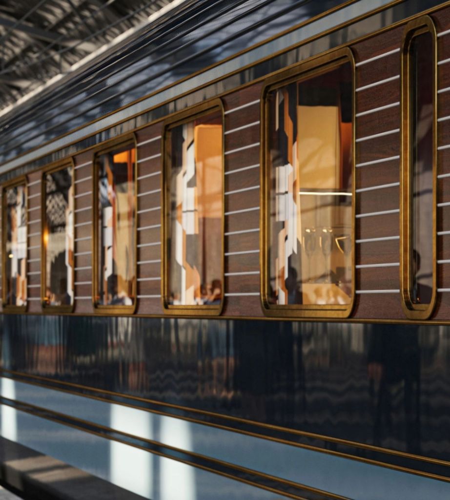 Close-up view of the luxurious exterior of the La Dolce Vita Orient Express train, showcasing its elegant design and distinctive windows.