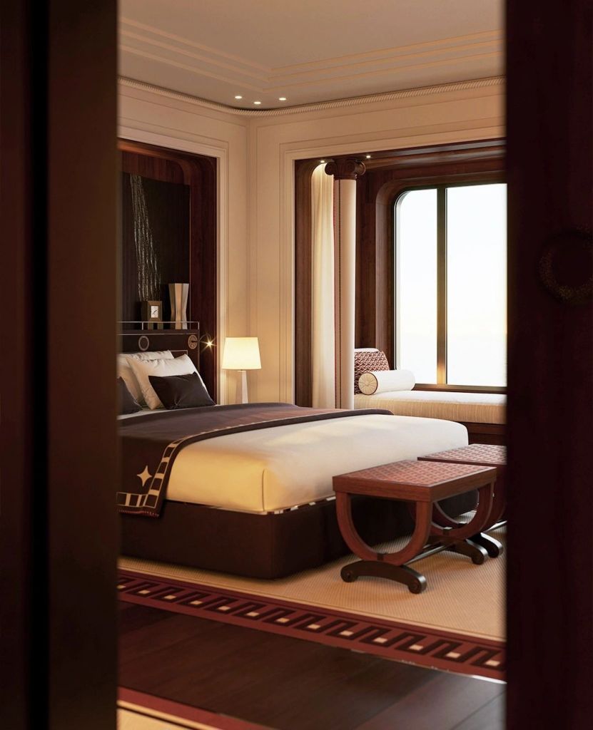 A luxurious suite on the Orient Express Corinthian yacht, showcasing elegant furnishings and ample natural light from large windows.