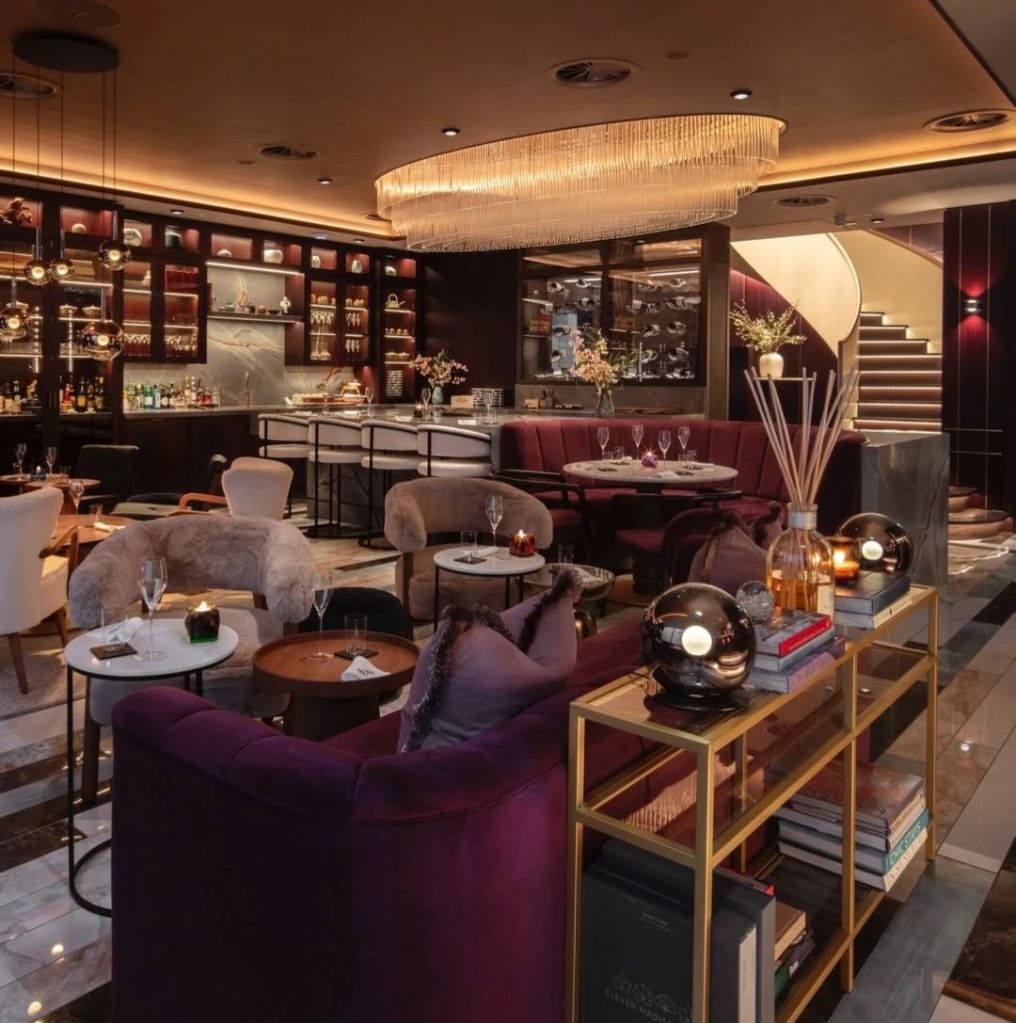 Interior of Row on 5 London, showcasing elegant furnishings, a luxurious bar area, and a warm, inviting atmosphere.