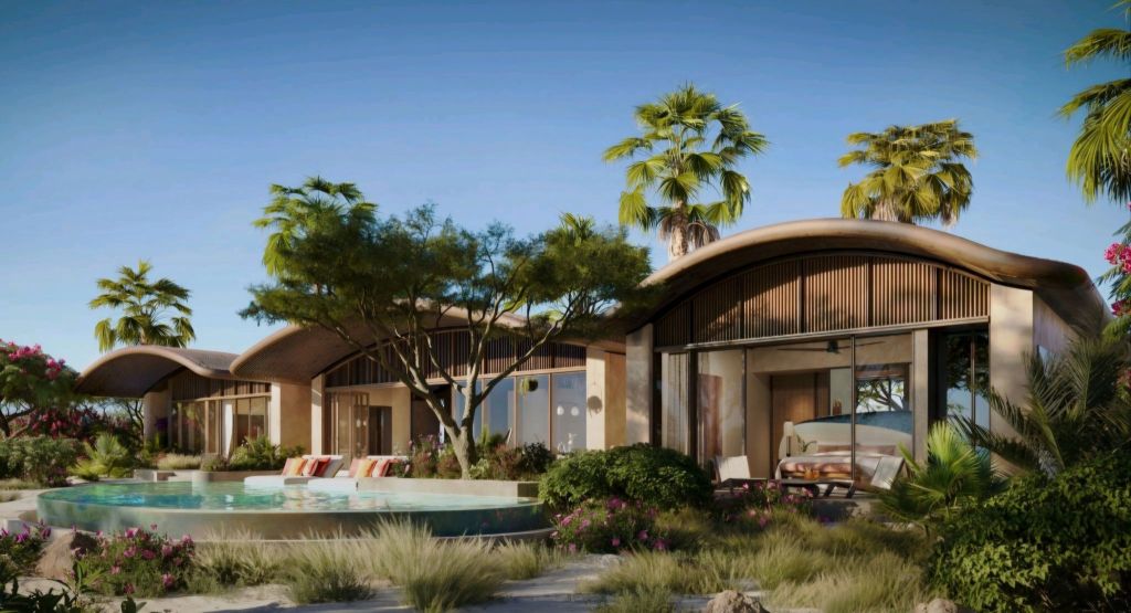 Luxury beachfront residences with modern architecture and lush landscaping, featuring a private pool and tropical plants.