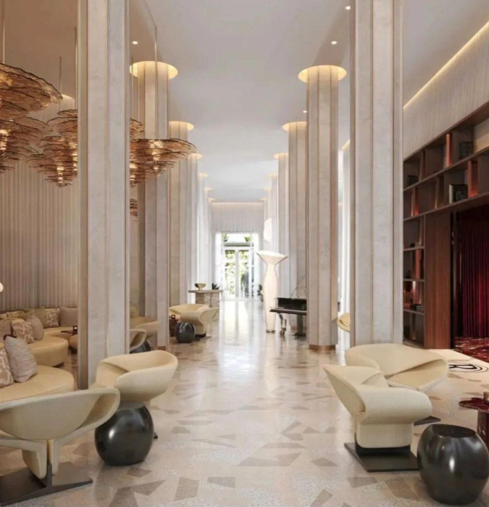 A luxurious hotel lobby featuring elegant seating, modern decor, and large windows allowing natural light, creating an inviting atmosphere.