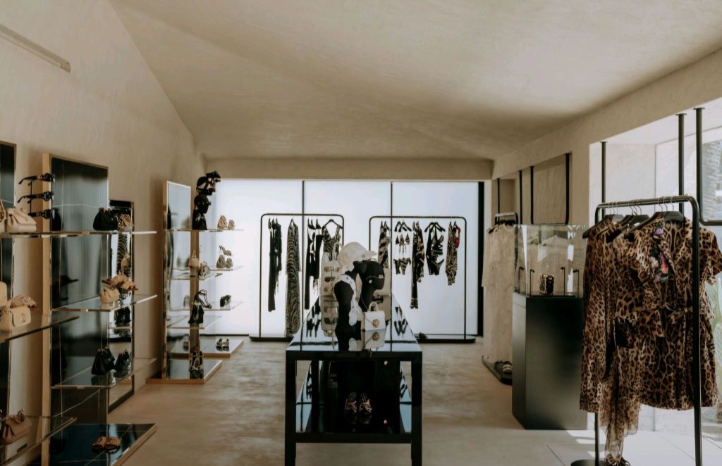 Interior view of the Dolce & Gabbana pop-up boutique at CLAP HOUSE IBIZA, showcasing stylish fashion items and accessories in a modern, elegantly designed space.