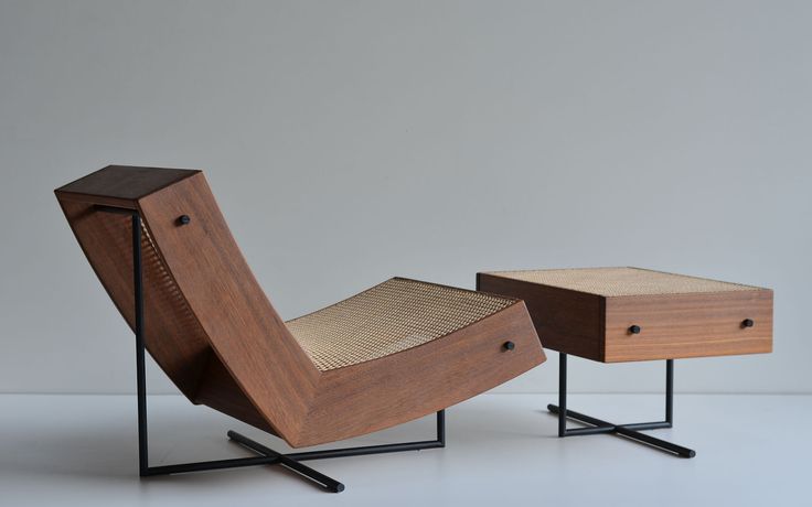 A modern wooden lounge chair with a woven seat and a matching side table, showcasing minimalist design and organic shapes.